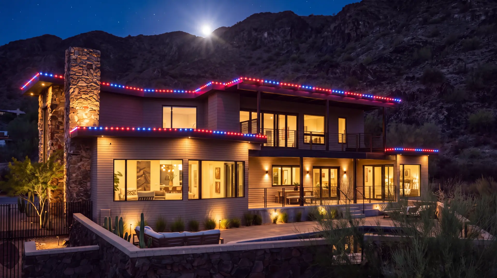 Home decorated with festive red, white and blue full-spectrum LED roofline lighting