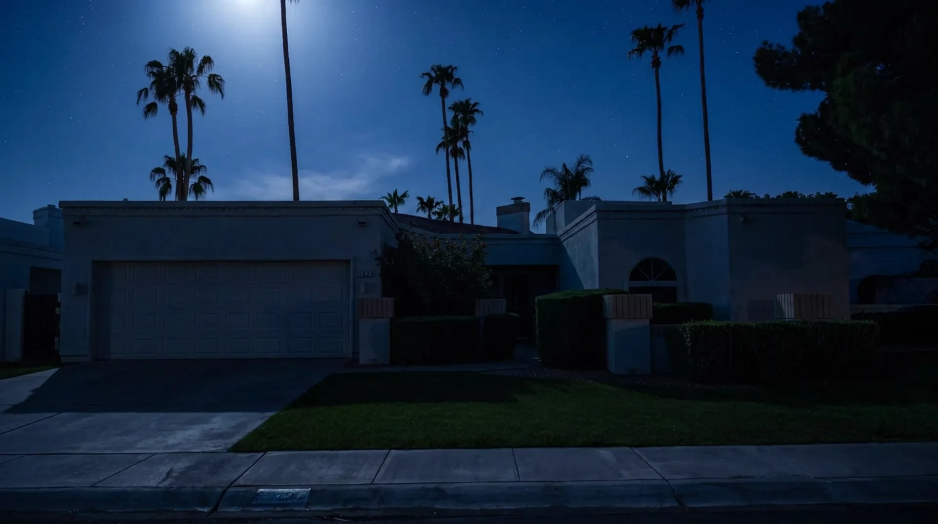Home exterior at night before Awaken Lighting installation